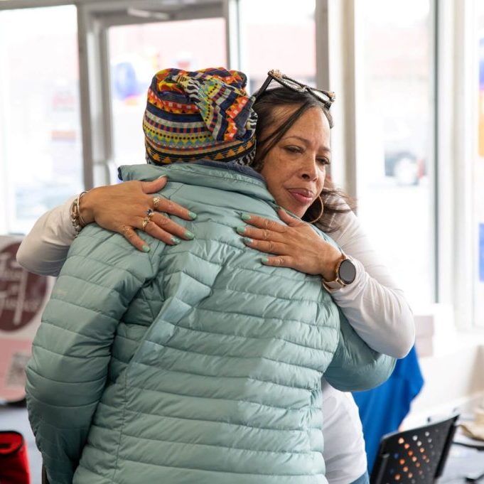 A woman hugging another person