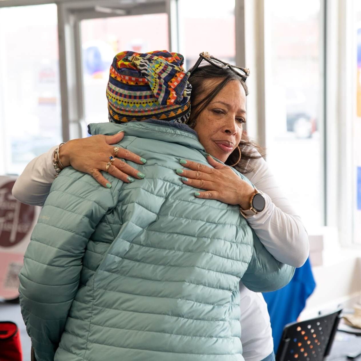 A woman hugging another person